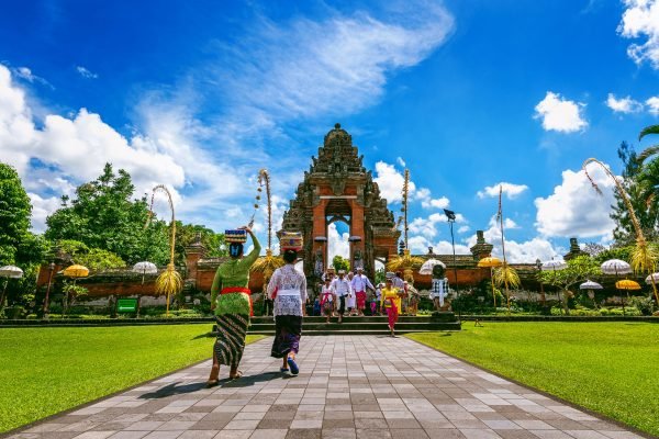 BALI, INDONESIA - APIRL 26, 2017 : Balinese people in traditional clothes during religious ceremony at Pura Taman Ayun Temple, Bali in Indonesia.