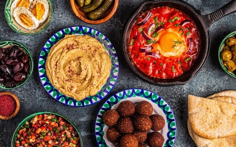 Falafel, hummus, shakshuka, Israeli salad - traditional dishes of Israeli cuisine. top view.