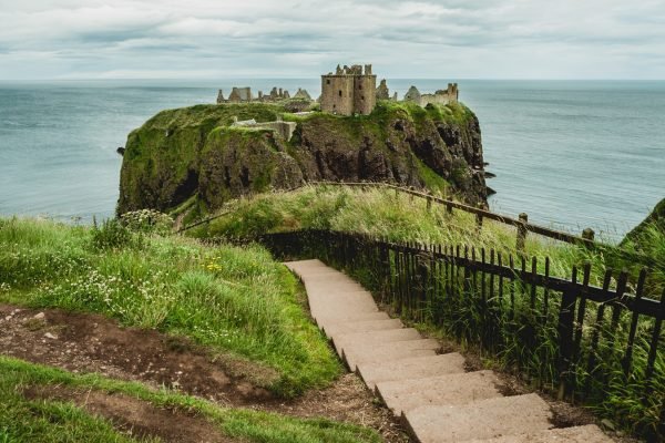 A picture of concrete stairs against Dunnottar Castle in Stonehaven, UK